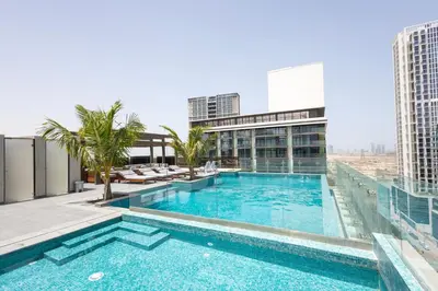 a swimming pool on the roof of a building at Spacious 2BR Apartment l Rooftop Pool l Gym in Dubai