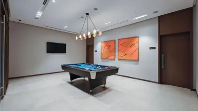 a room with a pool table in a room at Luxury 4BR Full Burj khalifa & Fountain View, 1Gbps, PS5 in Dubai
