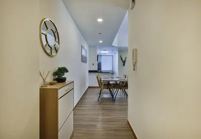 a kitchen and dining room with a table and a mirror at Near Metro Station - 1BR in Marina Diamond 3, Dubai Marina - Allsopp & Allsopp in Dubai