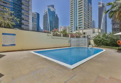 a swimming pool in a city with tall buildings at Near Metro Station - 1BR in Marina Diamond 3, Dubai Marina - Allsopp & Allsopp in Dubai