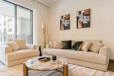 a living room with a couch and a table at FAM Living - Modern 1BR at Orchid, Creek Harbour in Dubai