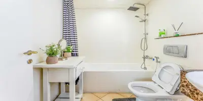 a bathroom with a toilet and a sink and a tub at 8min Walk from JBR beach Stylish 1-Bedroom Apartment in Dubai Marina in Dubai