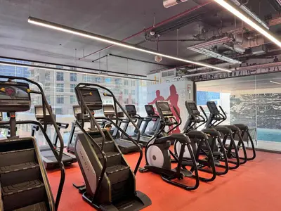 a gym with a bunch of exercise bikes in it at Stylish 2BR in Royal MBL in Dubai