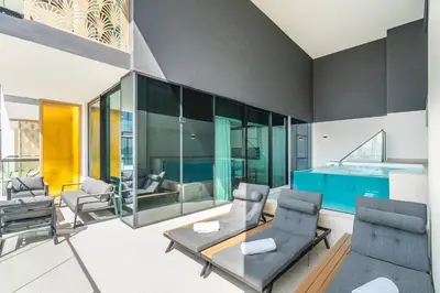 a living room with chairs and a table at Vibrant - 2BR - Exclusive Pool, Shared Gym in Dubai