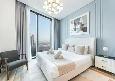 a bedroom with a large white bed and a chair at Modern Stay at The Address JBR in Dubai