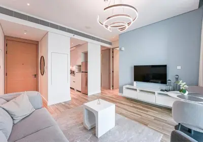a living room with a couch and a tv at Modern Stay at The Address JBR in Dubai