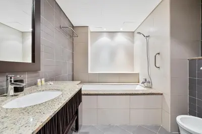 a bathroom with two sinks and a tub and a shower at Spacious 2 Bed Unit With Aquaventure Waterpark Views in Dubai