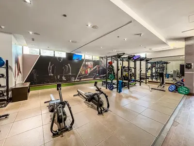 a gym with bikes and exercise equipment in a room at Spacious 2 Bed Unit With Aquaventure Waterpark Views in Dubai