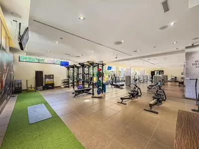 a gym with treadmills and exercise bikes in a room at Spacious 2 Bed Unit With Aquaventure Waterpark Views in Dubai