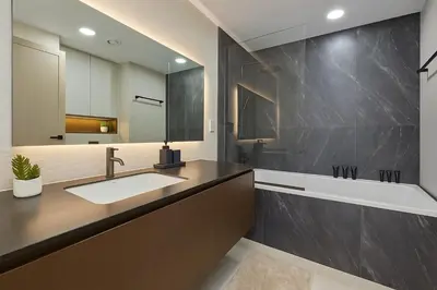 a bathroom with a sink and a large mirror at New Renovated Stylish 1 Br Dubai View 73 Floor in Dubai