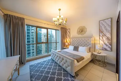 a bedroom with a bed and a large window at Spacious 2 bedroom apartment in Downtown Dubai in Dubai