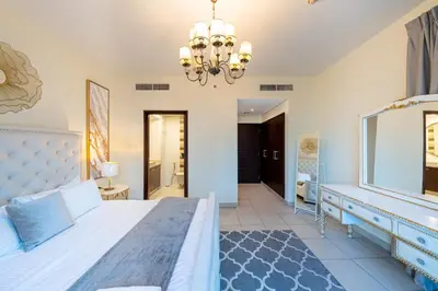 a bedroom with a large bed and a mirror at Spacious 2 bedroom apartment in Downtown Dubai in Dubai
