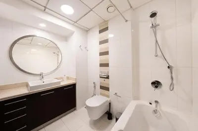 a bathroom with a sink toilet and a mirror at Spacious 2 bedroom apartment in Downtown Dubai in Dubai