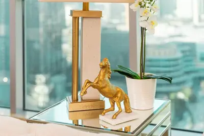 a glass table with a figurine of a horse on it at Elite Royal Apartment - Sky Series - Best Burj Khalifa & Fountain View - High Floor - Visionary in Dubai