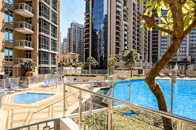 a balcony with a swimming pool in a city at Elite Royal Apartment - Sky Series - Best Burj Khalifa & Fountain View - High Floor - Visionary in Dubai