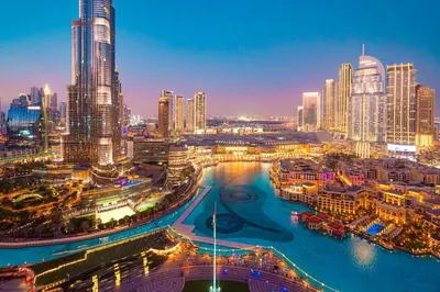 a city skyline at night with a river and buildings at Elite Royal Apartment - Sky Series - Best Burj Khalifa & Fountain View - High Floor - Visionary in Dubai