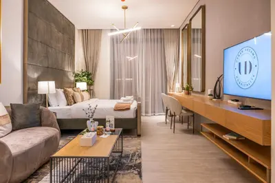a hotel room with a bed and a tv at Brand New Designer Studio - Urban Retreat in JVC in Dubai