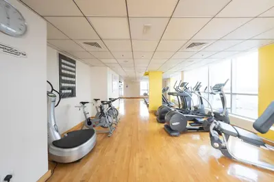 a gym with treadmills and bikes in a room at Bright and Modern Condo in Dubai Marina in Dubai