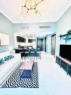 a living room with a white couch and a table at Bright and Modern Condo in Dubai Marina in Dubai