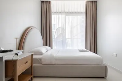 a bedroom with a bed and a window at Luxury2BR Canal View Free parking & water Downtown in Dubai