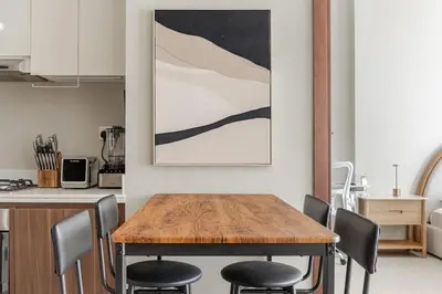 a kitchen with a wooden table and chairs at Luxury2BR Canal View Free parking & water Downtown in Dubai