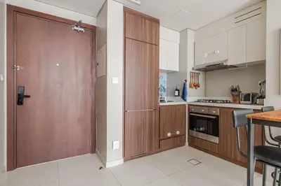 a kitchen with a wooden door and a counter at Luxury2BR Canal View Free parking & water Downtown in Dubai