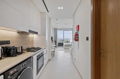 a kitchen with a stove and a counter top at Daniels Studio at Marasi Drive with Canal View in Dubai