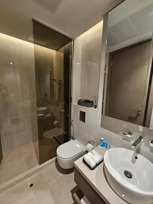 a bathroom with a toilet and a sink and a shower at Luxury Fully Furnished One Bedroom in Dubai