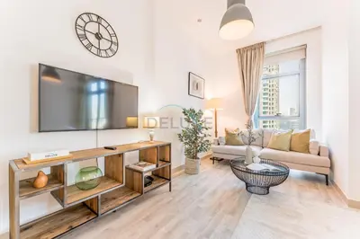 a living room with a large flat screen tv at Downtown Luxury Large Studio Near Burj Khalifa with City Views, - Claren Tower 1, Downtown Dubai by Deluxe Holiday Homes in Dubai
