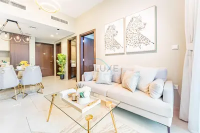 a living room with a white couch and a table at City and Burj Khalifa View 2BR, Near Dubai Water Canal, Vera Tower, Business Bay by Deluxe Holiday Homes in Dubai
