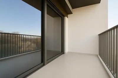 an empty balcony with a glass door with a view at Sleek New Studio in Meydan, Fully Equipped and Spacious in Dubai