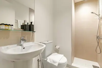 a bathroom with a sink and a toilet and a shower at Luxury 3BR Downtown Apt with Burj Khalifa, Dubai Mall & Opera House Views in Dubai