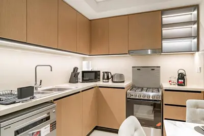 a kitchen with a sink and a stove top oven at Luxury 3BR Downtown Apt with Burj Khalifa, Dubai Mall & Opera House Views in Dubai