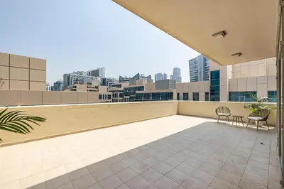 a balcony with chairs and a view of the city at 1BR plus Extra Bedroom Bay Square B7, City View in Dubai