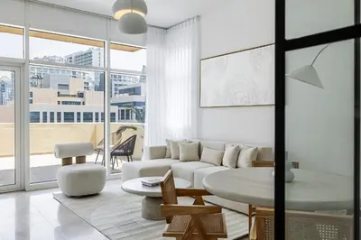 a living room with a white couch and a table at 1BR plus Extra Bedroom Bay Square B7, City View in Dubai