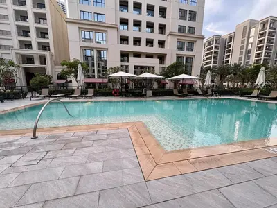 a large swimming pool in front of a building at FIRST CLASS 2BR Design Meets Comfort in Dubai