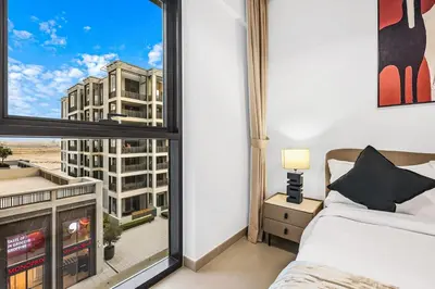 a bedroom with a window with a view of a building at FIRST CLASS 2BR Design Meets Comfort in Dubai