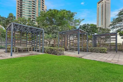 a pavilion in a park with grass and buildings at FIRST CLASS 1BR Majestic Burj Khalifa View in Dubai