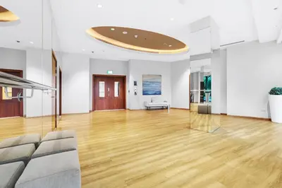 a living room with a wooden floor and a ceiling at FIRST CLASS 1BR Majestic Burj Khalifa View in Dubai