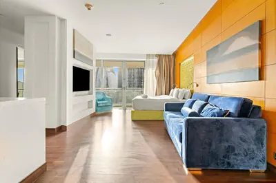a living room with a couch and a bedroom at FIRST CLASS Studio Stunning Burj Khalifa Views in Dubai