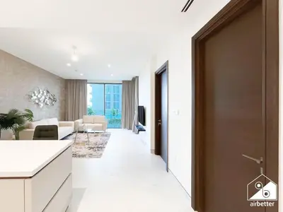 an open hallway with a living room and a door at Stunning 2-Bed Home in Sobha Creek Vistas in Dubai