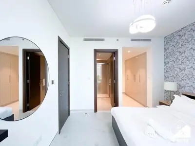 a bedroom with a mirror and a bed at Stunning 2-Bed Home in Sobha Creek Vistas in Dubai