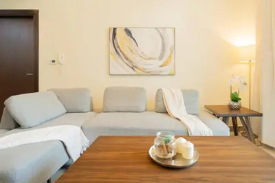 a living room with a couch and a table at 2BR Spacious Pearl with Stunning City Views - Holiday Boulevard in Dubai