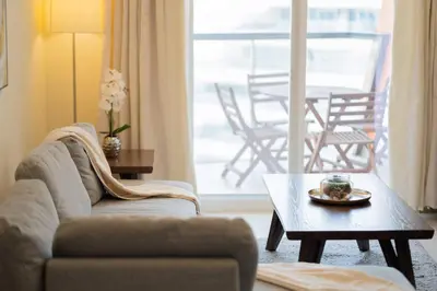 a living room with a couch and a coffee table at 2BR Spacious Pearl with Stunning City Views - Holiday Boulevard in Dubai
