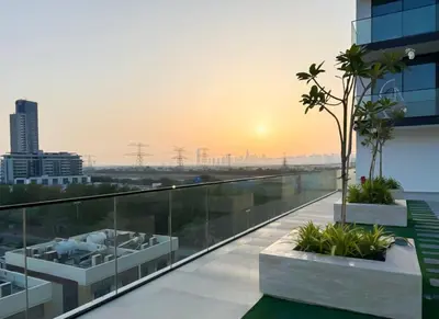 a balcony of a building with a sunset in the background at Onyx 1BR with Stunning City Views in Dubai