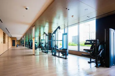 a gym with a row of treadms and elliptical machines at Luxury 1BR on High Floor JVC in Dubai