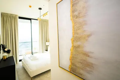 a large painting on the wall of a bedroom at Luxury 1BR on High Floor JVC in Dubai