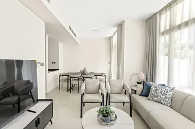 a living room with a couch and a table at Tranquil 3BR Villa with Malibu Beach Access in Dubai