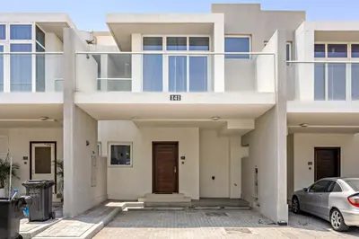 a white house with a car parked in front of it at Tranquil 3BR Villa with Malibu Beach Access in Dubai