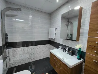 a bathroom with a sink and a mirror at Modern Studio with free Netflix - Close to Metro in Dubai